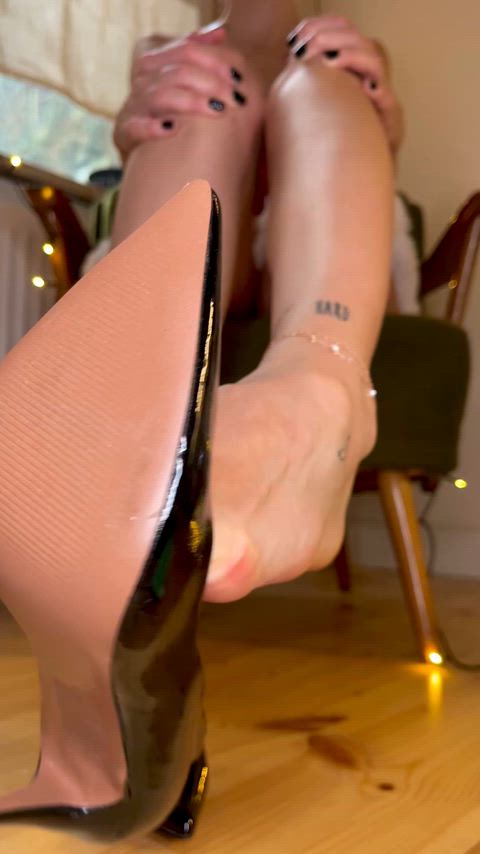 Removing my heels to reveal my sole