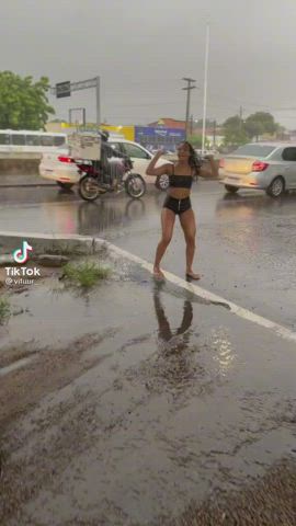 Brazilians twerking while its raining in a highway