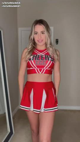 Cute cheerleader giving you a peak at her goods