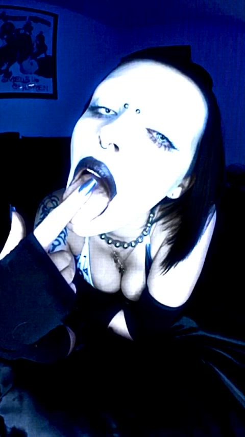 big tits cleavage drool eye contact finger in mouth goth spit sucking tattooed tongue