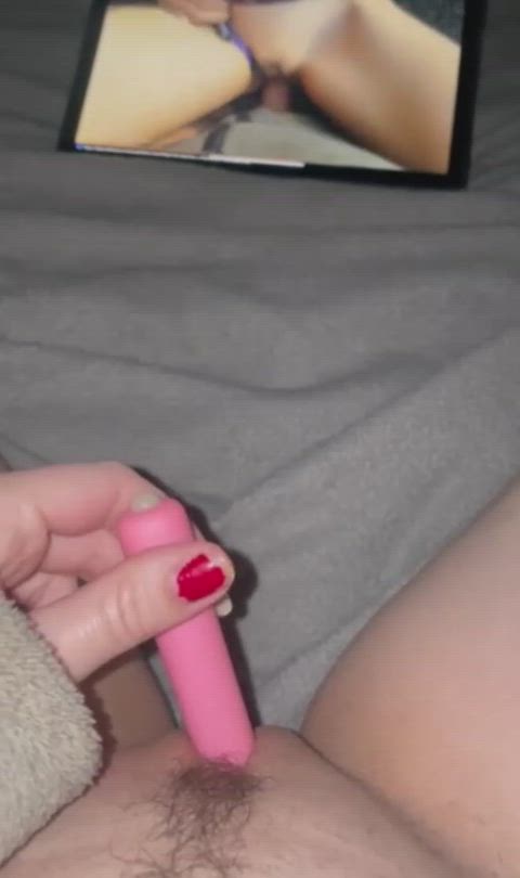 ....watching porn and stimulating clitoris with a vibrator until orgasm