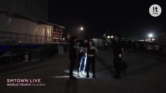 irene dancing in a car park while sweating