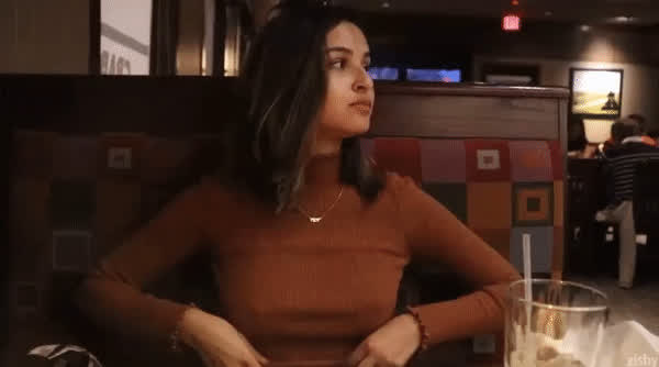 Beautiful girlfriend showing her perfect tits in a restaurant