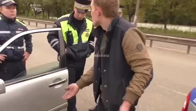 Man knocks officer's cap of his head...