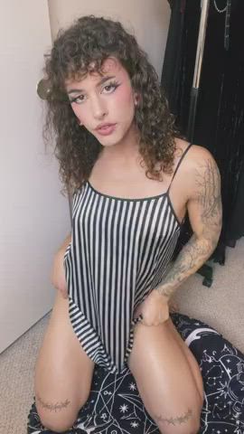 Curly haired brunette with something up her skirt