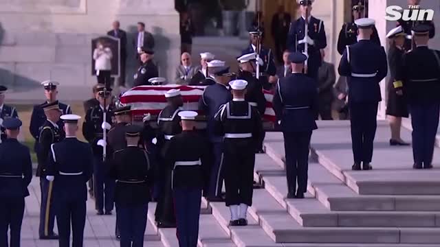 Emotional George W. Bush watches his father's casket arrive at Capitol