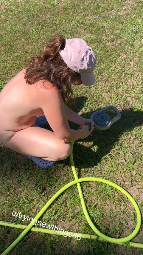 Setting up the sprinkler on a hot day 