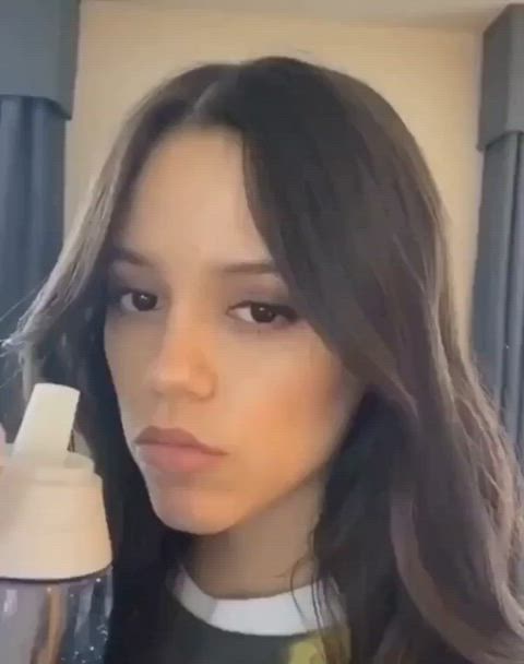 Jenna Ortega winking to let you know she is dreaming that she was drinking watery