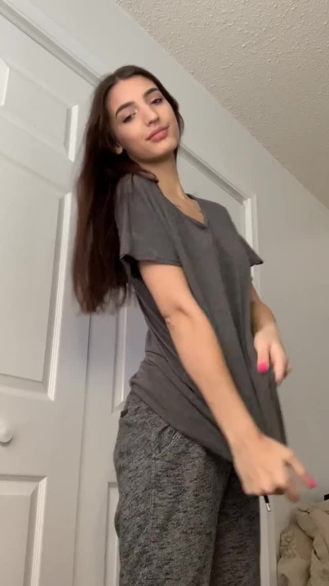 Petite brunette showing her tits and ass