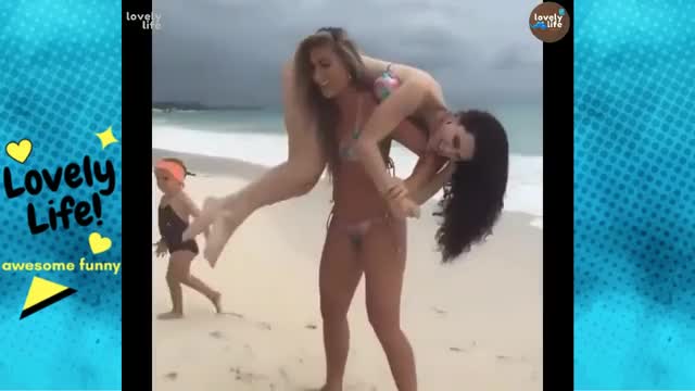 Fitness Girl lifting girl in beach