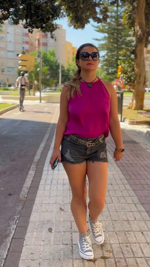 Walking the streets in a hot pink top.