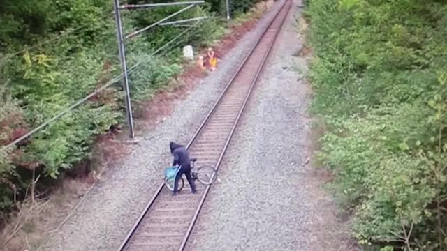 Hero rail worker saves stumbling cyclist from oncoming train! (Near Miss!!)