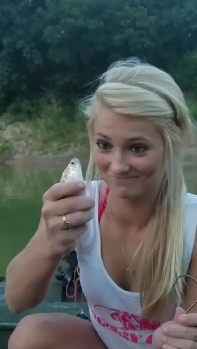 Girl Bites Head off Fish for Bait