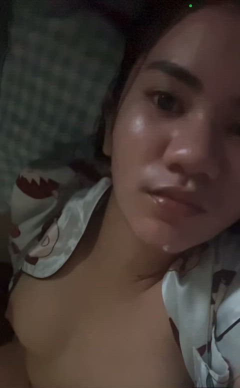 Filipina slut from Davao City lays naked on her back, showing off her perfect tits