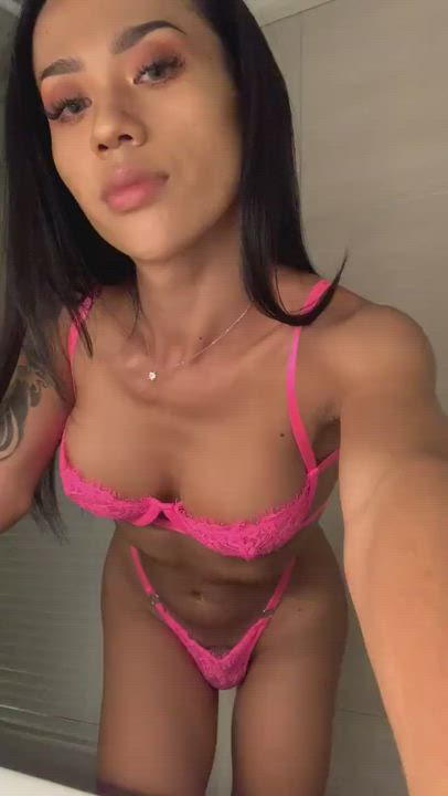 She looks awesome in pink lingerie