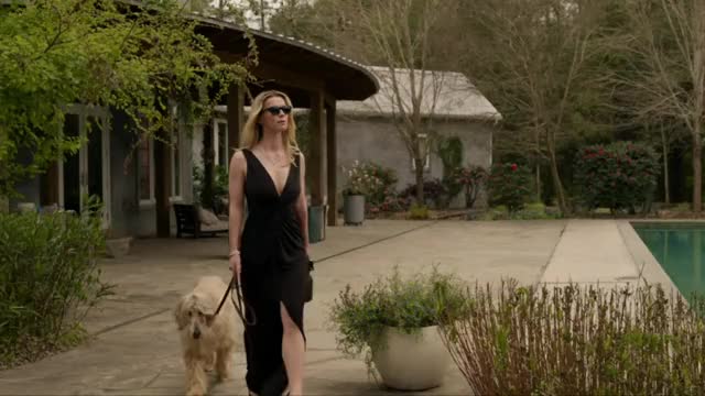 Betty Gilpin - The Hunt (2020) - cleavage, walking in black dress (short clip, slightly