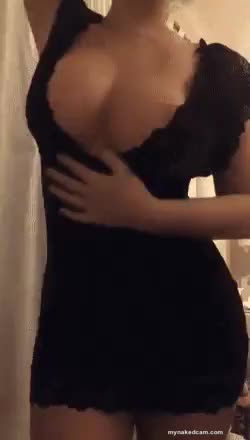 Hot curvy girl in black tight dress showing her boobs
