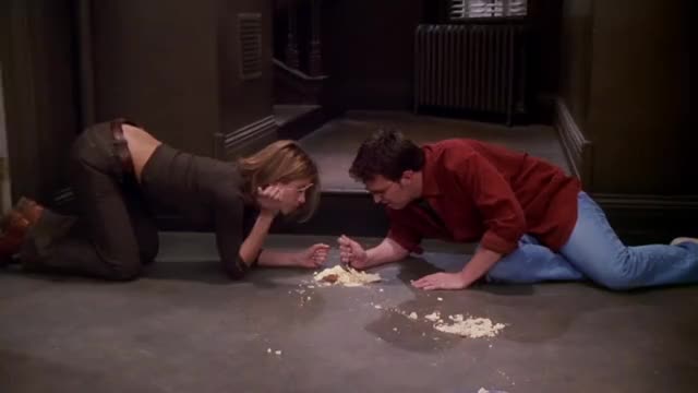Jennifer Aniston on all fours eating cheesecake off the floor.