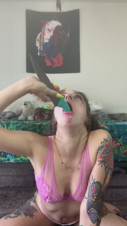 Putting a dildo down her throat