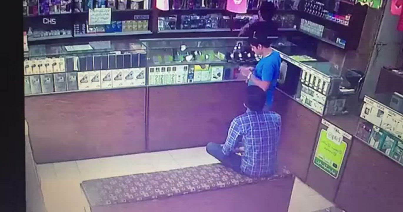 Man lights up cigarette in a store having gas leakage