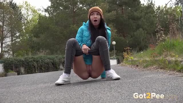 European girl decides to relieve her pee desperation at a hotel car park - Watch