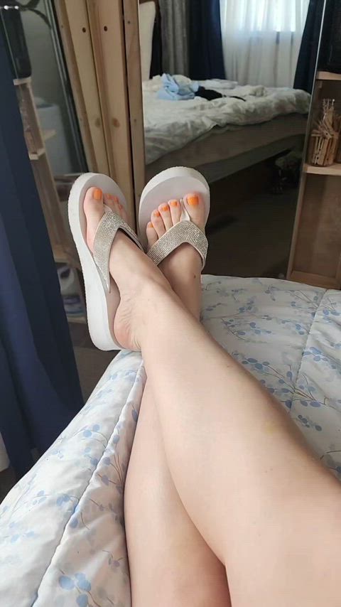 Orange nail polish & white flip flops