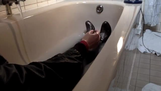 Bath wetlook in leather boots, leather jacket, tight pants and a red dress