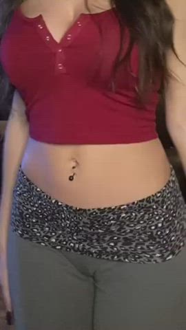 Her red snap button crop top goes well with her grey yoga pants