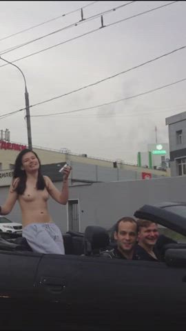 Topless girl riding the convertible