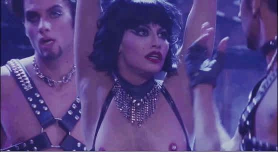 Gina Gershon's leather bra shows off her pierced nips.