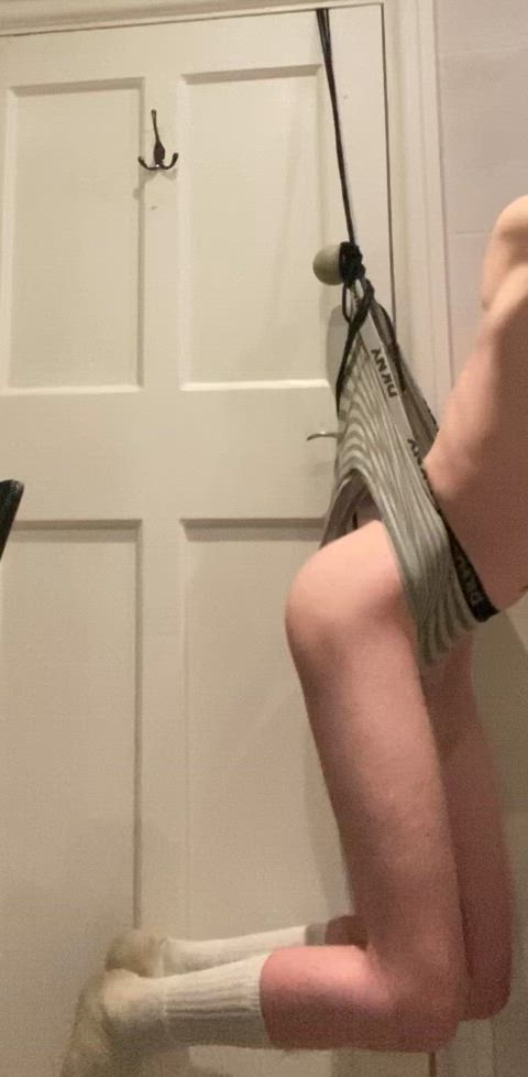 Stripped nerd in a hanging wedgie