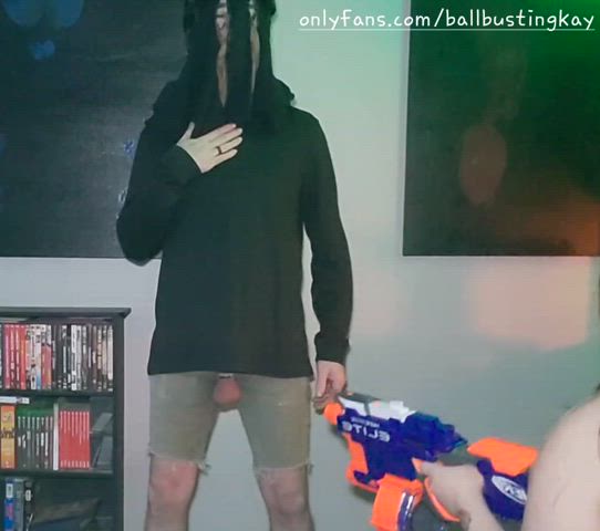 Playful ballbusting cosplayer with nerf gun